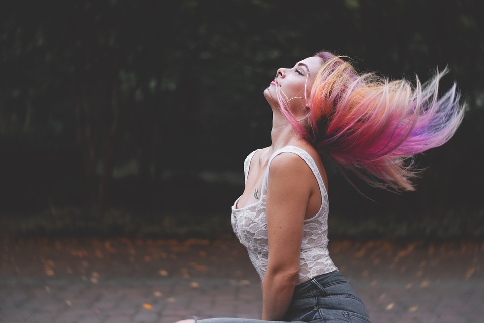 femme secouant ses cheveux avec plusieurs couleurs