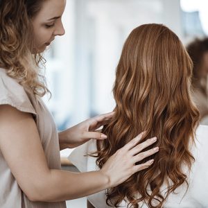 montreal stylist examines woman's hair color