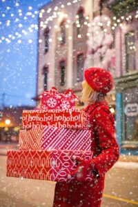 woman carrying holiday gifts including beauty haircare sets