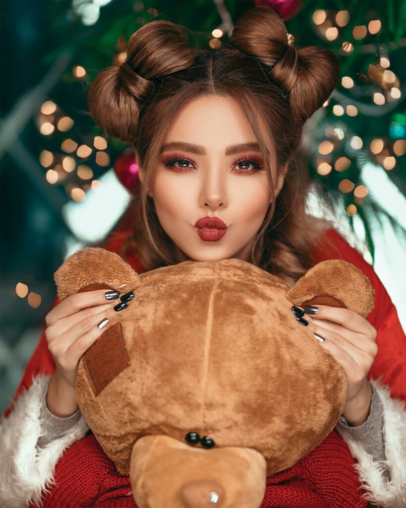 pretty woman at christmas time with stuffed toy