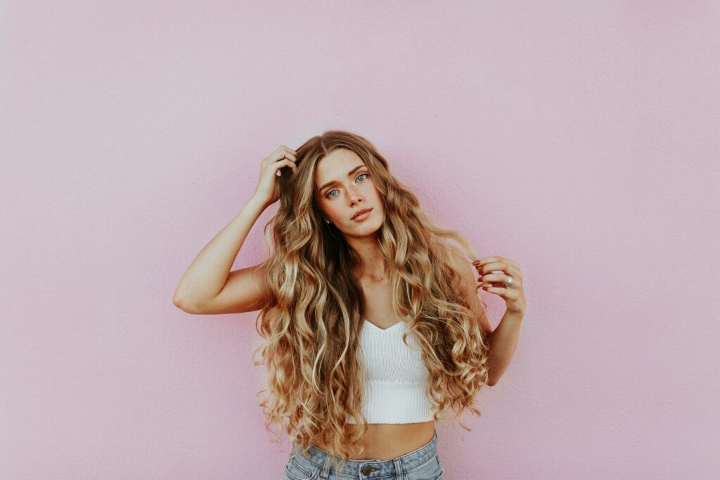 Girl with long curly hair after adding hair extensions